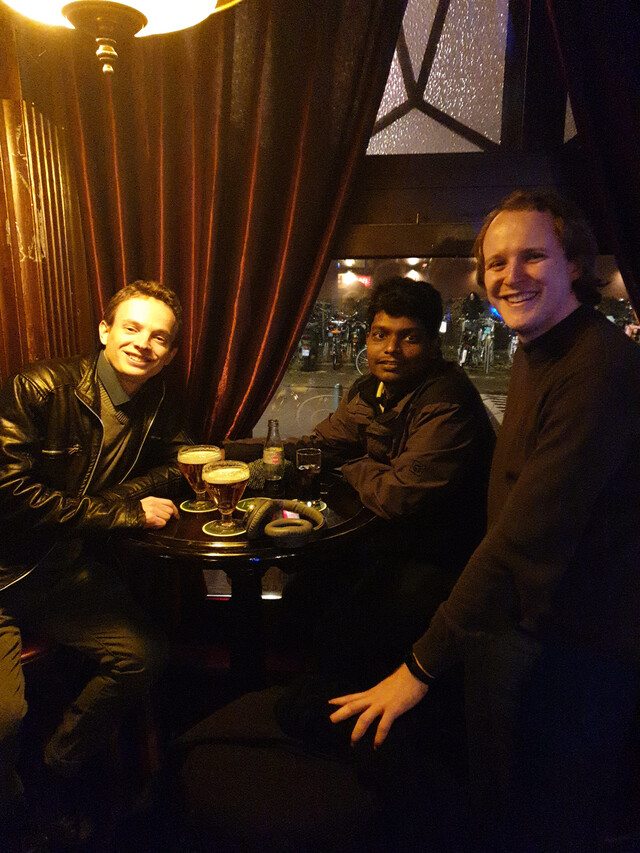 From left to right, Pierre, me and Jelle at a bar with surroundings lit an incandescent yellow