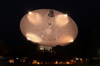 A large parabolic antenna seen in the night