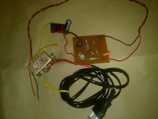 Perforated circuit board with power supply circuitry attached to a transformer and a mains power plug