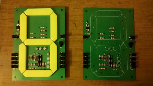 Two quiz buzzer PCBs side by side -- one with the seven segment display, and one without