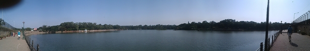 A panoramic view of a reservoir with paved paths on the left and right ends
